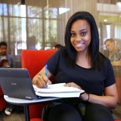 Student patron doing homework at a desk.