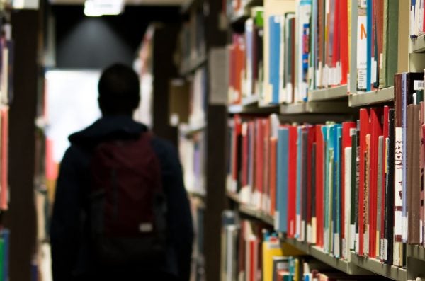 A patron in the Library book stacks.