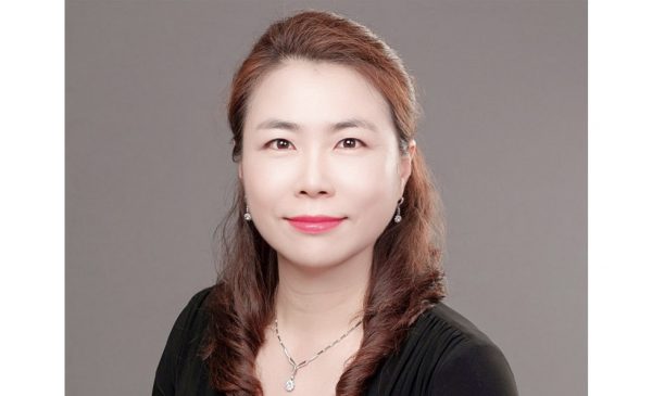 Portrait of Dr. Jung Mi Scoulas wearing black jacket, and a necklace and earrings.