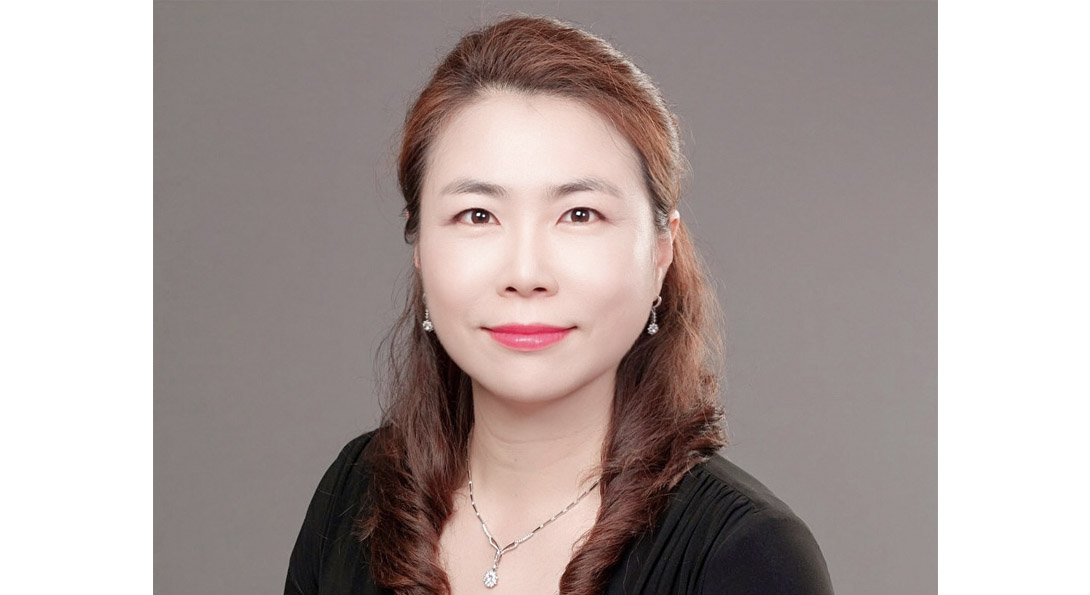 Portrait of Dr. Jung Mi Scoulas wearing black jacket, and a necklace and earrings.