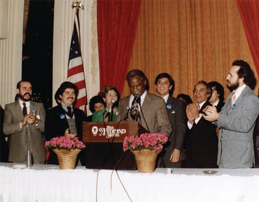 Community activist Rodolfo “Rudy” Lozano, (second from left) who attended the University of Illinois Chicago in the 1970s and was instrumental in the election of Mayor Harold Washington (center), is the subject of a new exhibit at the Richard J. Daley Library on the UIC campus. (Photo: Rodolfo “Rudy” Lozano archives)