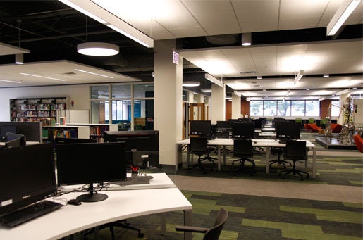 First floor of the Library of the Health Sciences-Chicago with computer stations and books in the background.